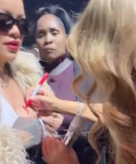 'This Is Iconic': Mariah Carey Signs Rihanna's Boob At Christmas Concert